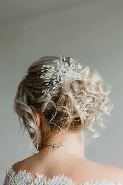 Elegant bridal updo with decorative hairpiece, perfect for wedding inspiration.